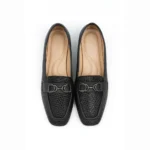 Sophisticated and versatile, Midnight Luxe is a chic ladies’ loafer designed for both formal and casual wear. Its textured black finish and metallic detail add a modern edge while keeping the look elegant.