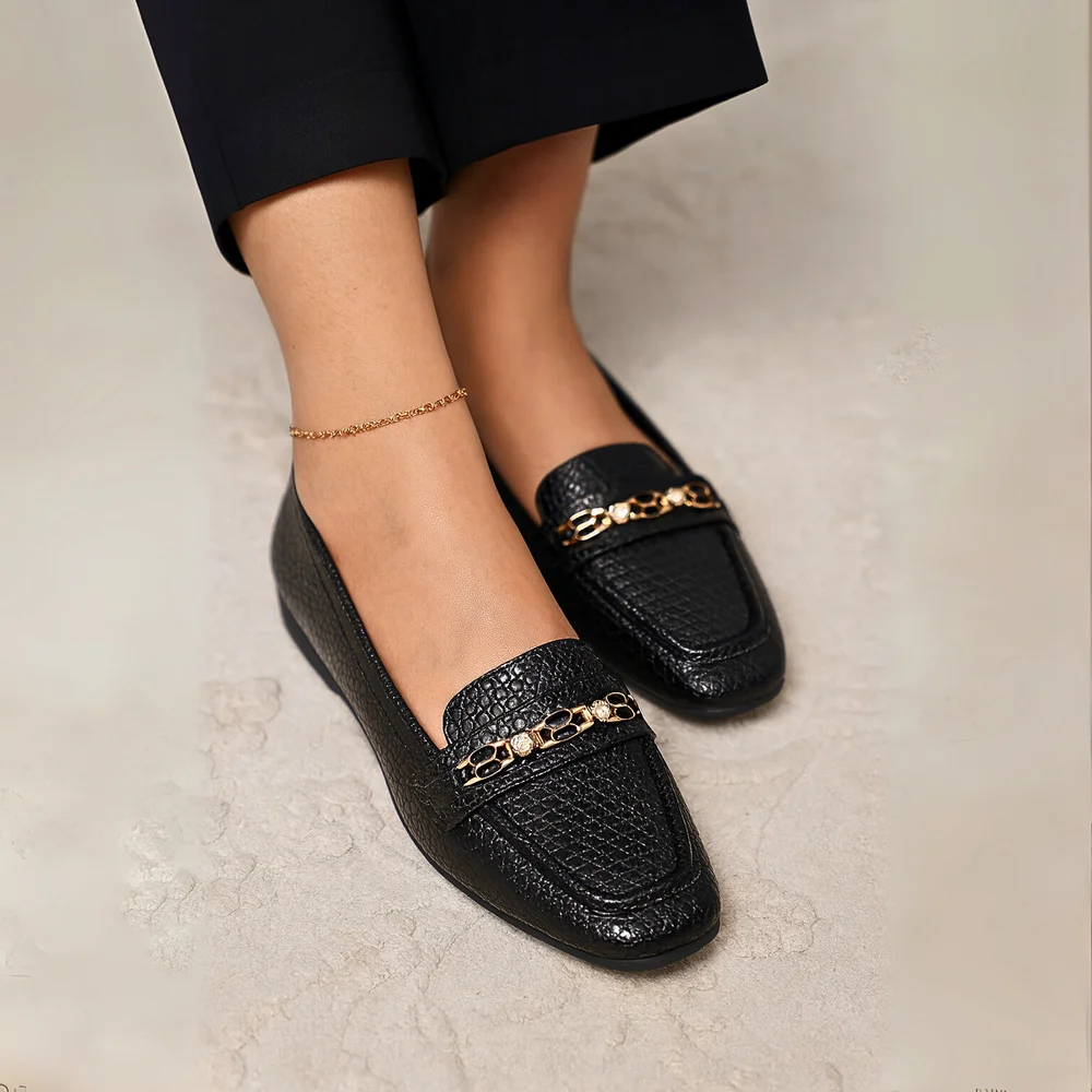 Sophisticated and versatile, Midnight Luxe is a chic ladies’ loafer designed for both formal and casual wear. Its textured black finish and metallic detail add a modern edge while keeping the look elegant.