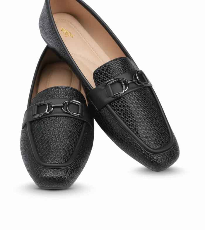Sophisticated and versatile, Midnight Luxe is a chic ladies’ loafer designed for both formal and casual wear. Its textured black finish and metallic detail add a modern edge while keeping the look elegant.