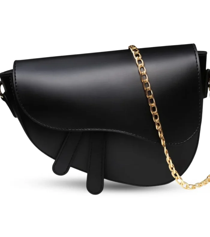 Mini black crescent-shaped saddle bag featuring a gold chain strap and smooth matte vegan leather.