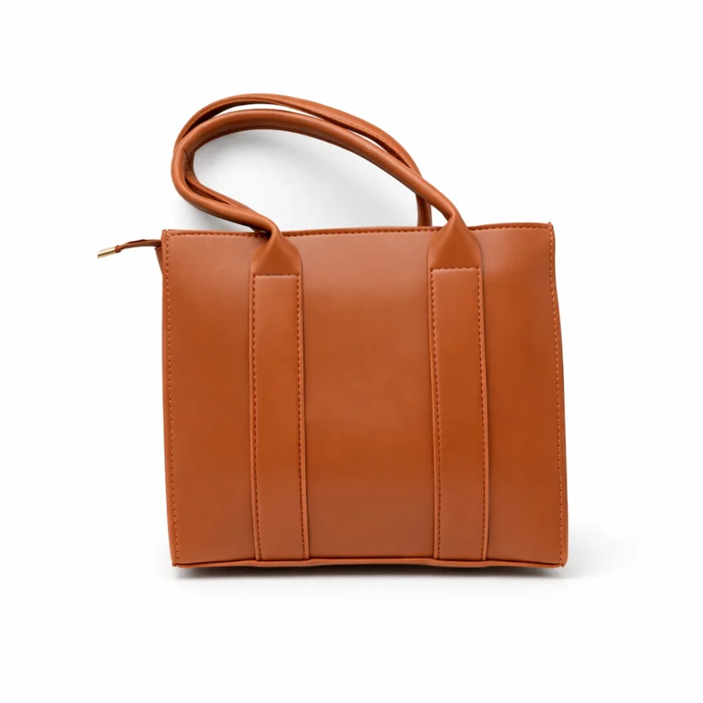 Structured tan vegan leather square tote bag with long shoulder handles and a minimalist smooth finish