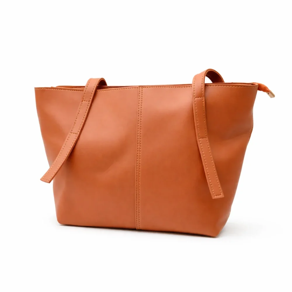 Front view of a caramel brown minimalist tote bag with a central seam detail and long shoulder straps.