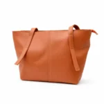 Front view of a caramel brown minimalist tote bag with a central seam detail and long shoulder straps.