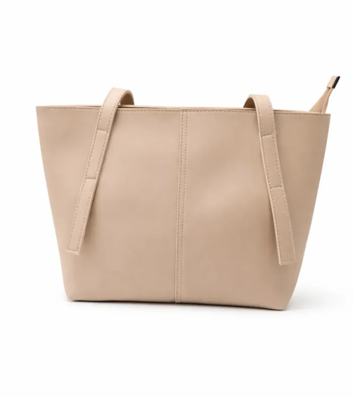 Front view of a soft nude beige minimalist tote bag with a central seam detail and long shoulder straps.