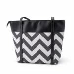 Large tote bag with a black and grey chevron pattern, black leather handles, and a secure top zipper.