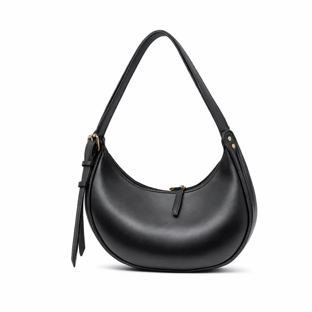 Side view of a smooth black crescent hobo bag with gold zippers and an integrated shoulder strap.