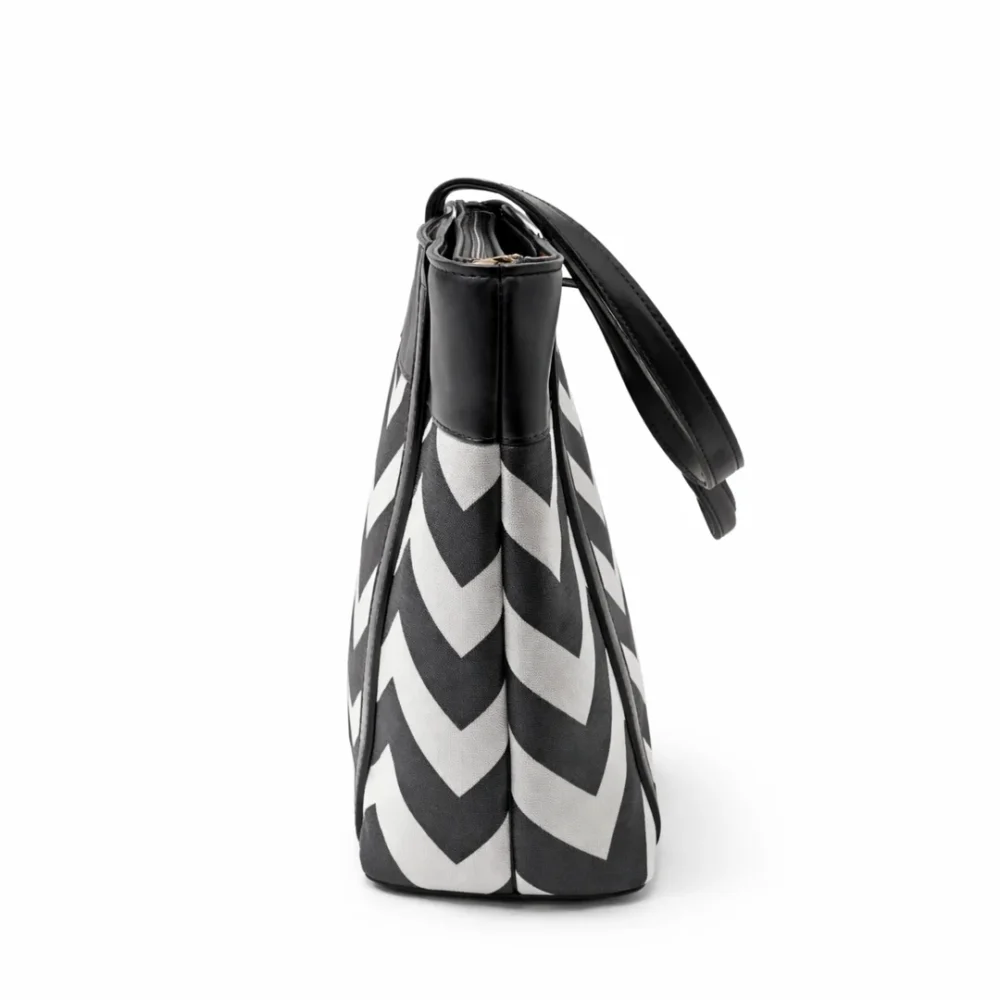 Large tote bag with a black and grey chevron pattern, black leather handles, and a secure top zipper.