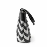 Large tote bag with a black and grey chevron pattern, black leather handles, and a secure top zipper.