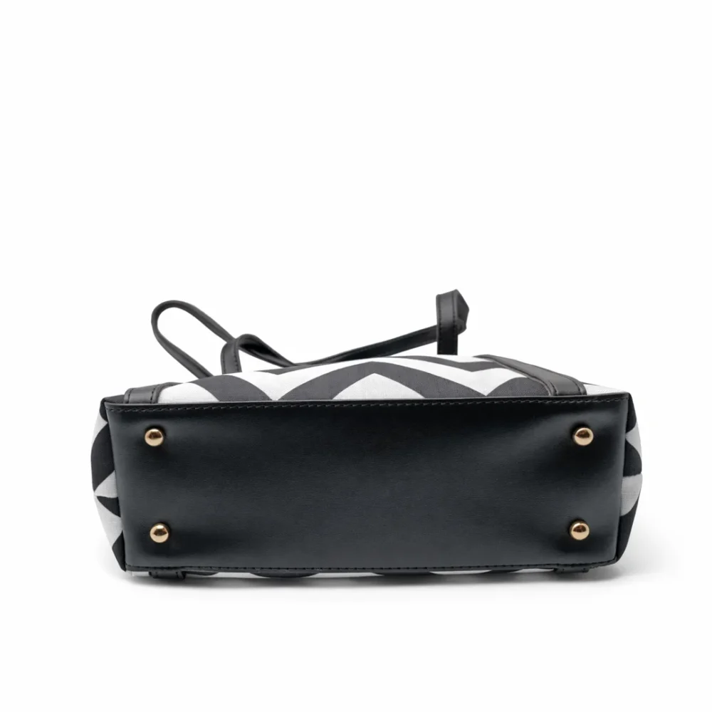 Large tote bag with a black and grey chevron pattern, black leather handles, and a secure top zipper.